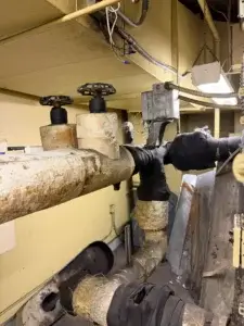 Insulated HVAC piping with valves in mechanical room