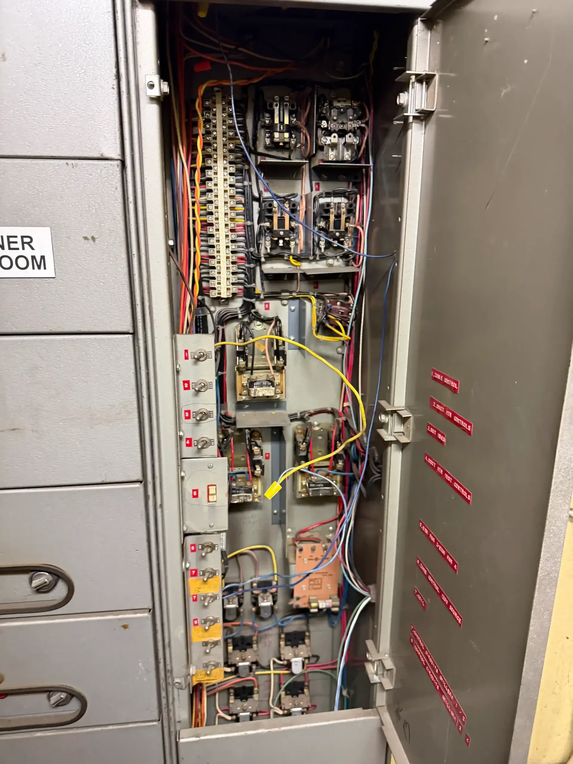 Open electrical control panel with wiring and relays